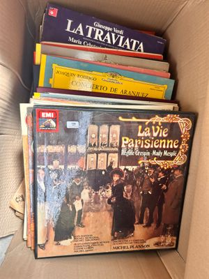 many books in a box that are sitting on top of each other