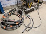 a machine that is sitting on the ground next to a bunch of hoses