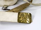 a belt with a gold buckle on it and a pair of scissors