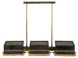 three black and gold boxes are sitting on top of each other