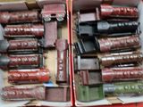 two boxes filled with different types of leather items
