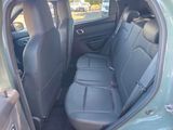 the back seat of a car with the door open in a parking lot