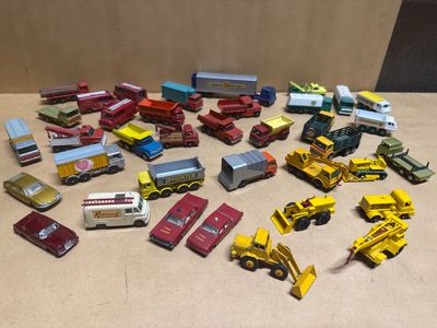 a lot of toy cars and trucks that are on the table