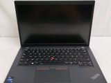 the laptop is open on a white surface with a black keyboard