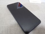 a black phone with a red, white, and blue sticker on it