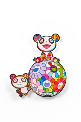 a close up of a panda bear sitting on top of a colorful ball