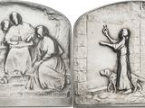 two silver reliefs of jesus and mary with a dog