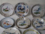 many plates with different designs on them on a table