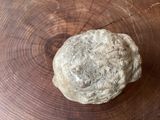 a ball of bread sitting on top of a wooden table