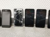 several cell phones are lined up in a row on the floor