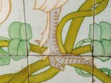 a tile with a bird on a branch on it