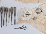 many different types of sewing tools laid out on a table