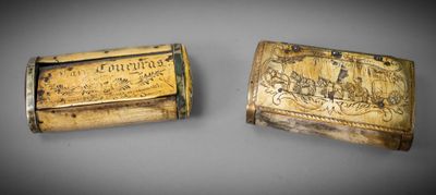 two wooden boxes with carvings on them sitting next to each other