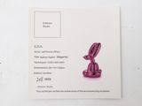 a close up of a pink object on a white surface