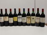 several bottles of wine are lined up in a row on a table