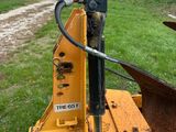a yellow machine that is sitting in the grass