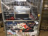 a metal cart with many items in it in a warehouse