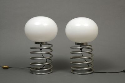 pair of white glass globe lamps on metal spring bases