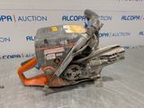 a close up of a chainsaw on a table with a sign in the background