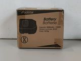 a box of batteries sitting on a table next to a white wall