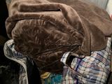 a pile of clothes in a suitcase on the floor