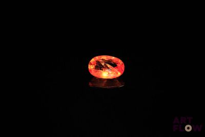 an orange diamond in the dark with a black background