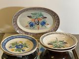 three bowls and a plate on a tray on a table