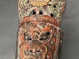 a close up of a mask on a table with a black background