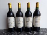 three bottles of wine are lined up on a table