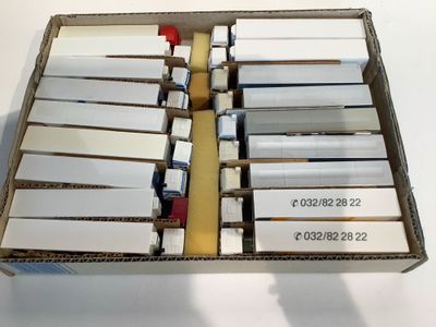 a box with a lot of white cards in it