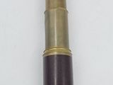an old brass telescope on a white surface with a white background