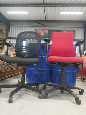 two chairs that are sitting on top of blue drums