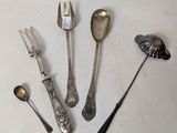 five different types of silverware on a white table