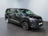 the black van is parked in a white room with a black floor