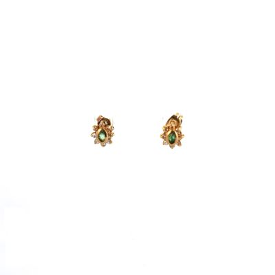 a pair of gold earrings with green stones on a white background