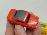 a person holding a toy car in their hand