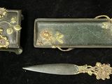 a knife and a box sitting next to each other on a black surface