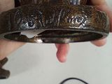 a person holding a hat with a cord in their hand