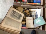 a box full of books on the floor with a person standing next to it