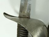 a close up of a sword with a metal handle