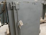 a metal box sitting on a pallet in a warehouse