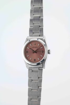 a close up of a watch on a white surface with a white background
