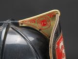 a close up of a fireman ' s helmet on a black background