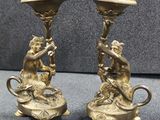 pair of antique brass candlesticks with monkeys on them