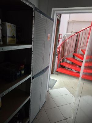 a red staircase going up to a red staircase in a room