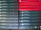 boxes of starbucks coffee sit on top of a table in a store