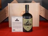 a bottle of liquor sitting next to a box on a table