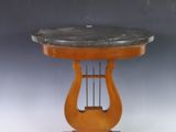 an antique wooden table with a black marble top and a wooden base