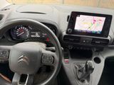 the interior of a car with a steering wheel, dash panel, and a gps device
