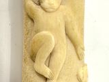 a statue of a woman holding a baby on a wall